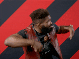 Video gif. Chris "The Action Man" Curtis raises his arms and looks up to the sky in an overly dramatic kind of way against a red and black striped background. Text, "Good morning!'