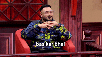 TV gif. Sitting in a courthouse chair, Badshah on Case Toh Banta Hai presses his palms together expectantly. Text, in Hindi, reads "Bas kar bhai."